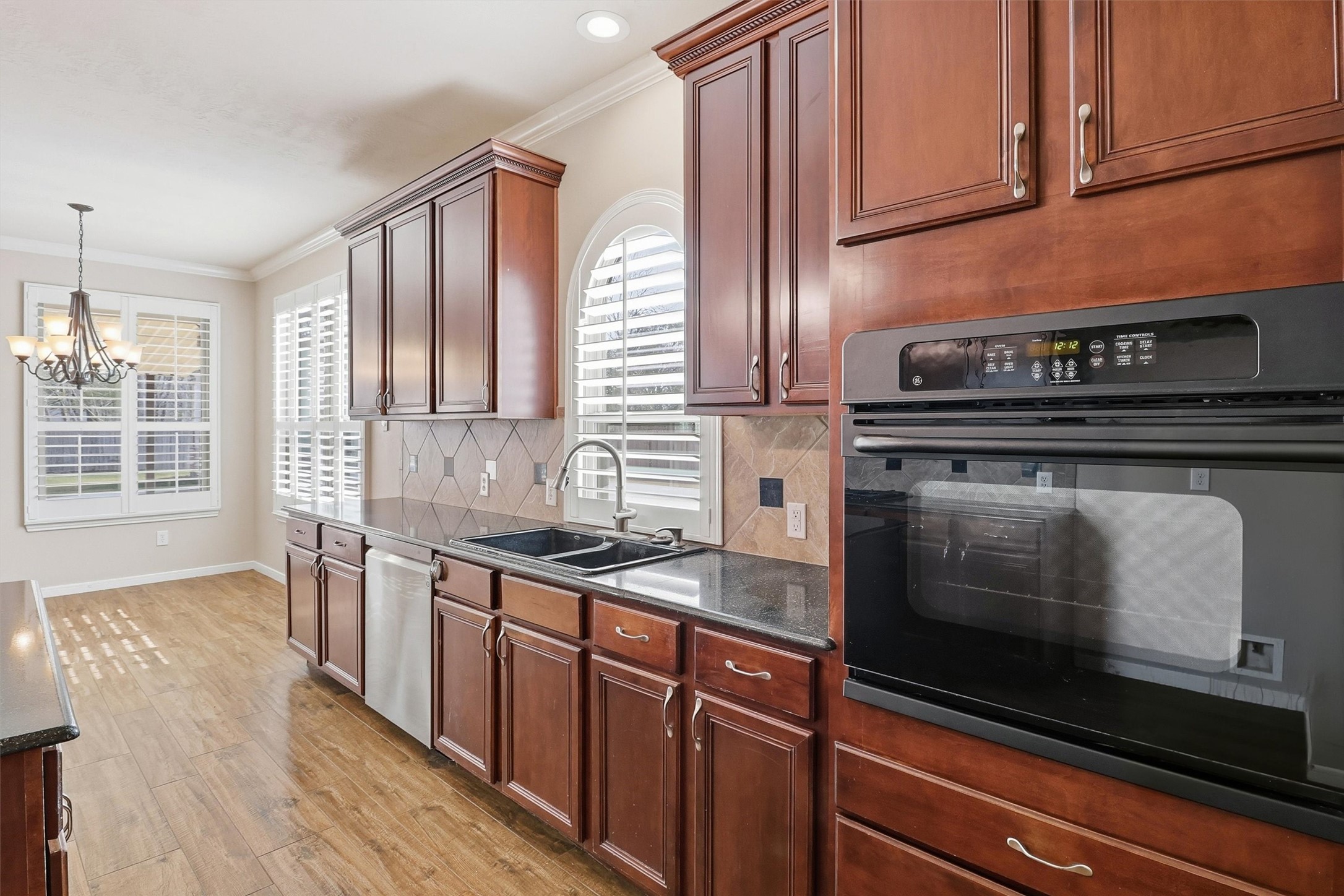 3602 River Bend Drive Rosenberg, TX 77471 - Photo 22 of 49 a kitchen with granite countertop a stove sink and cabinets