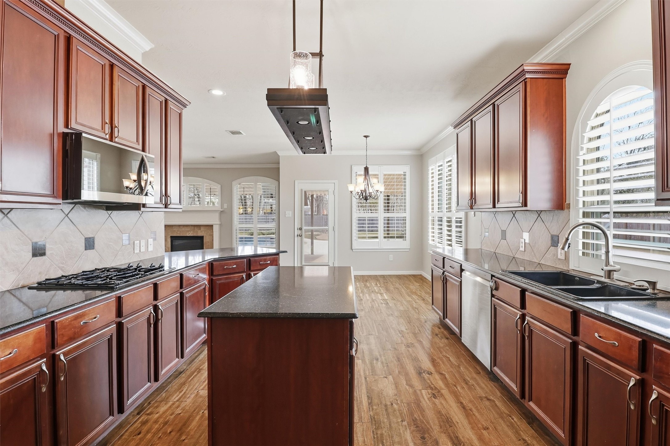 3602 River Bend Drive Rosenberg, TX 77471 - Photo 23 of 49 a kitchen with stainless steel appliances granite countertop a sink stove cabinets wooden floor and view living room
