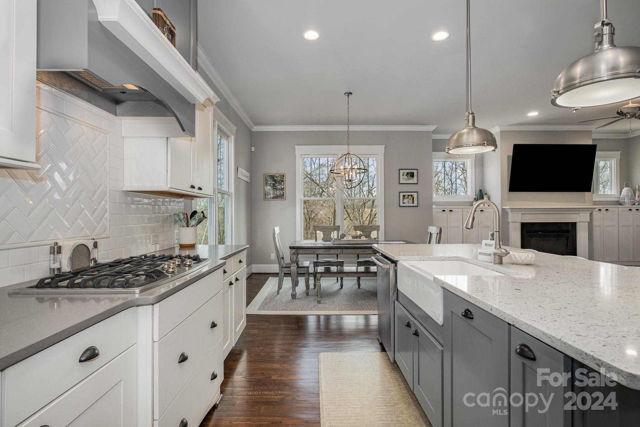 2289 Tatton Hall Road Fort Mill, SC 29715 - Photo 4 of 48 a kitchen with granite countertop a sink stove and cabinets