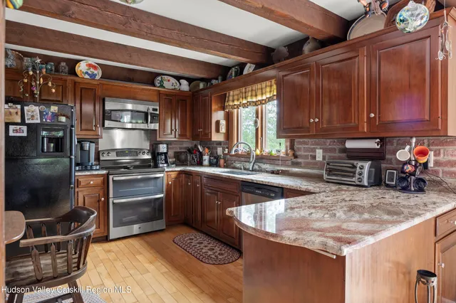 a kitchen with a stove sink and cabinets