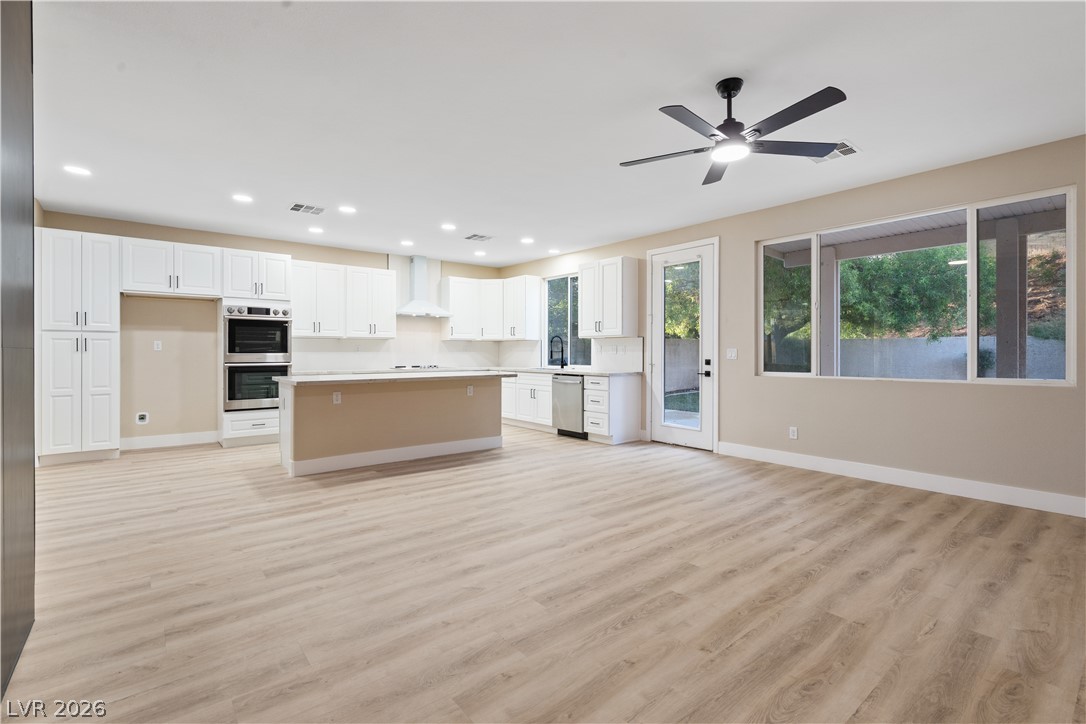 1662 Ravanusa Drive Henderson, NV 89052 - Photo 15 of 74 An open-concept living space integrates a pristine kitchen with sleek appliances and generous counter space.