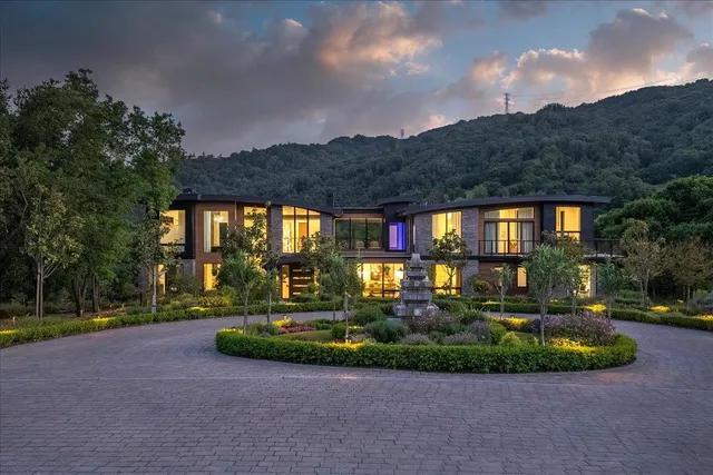 a dining room with furniture potted plants and wooden floor
