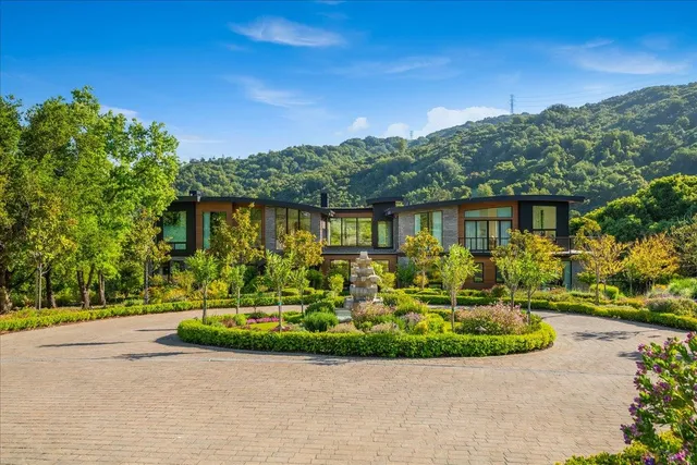 a kitchen with stainless steel appliances granite countertop a sink and a stove