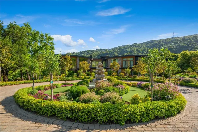 a dining room with furniture a large window and wooden floor