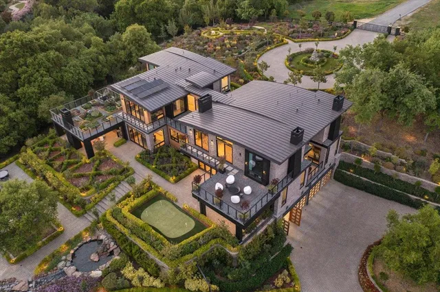 a living room with furniture a fireplace and a floor to ceiling window