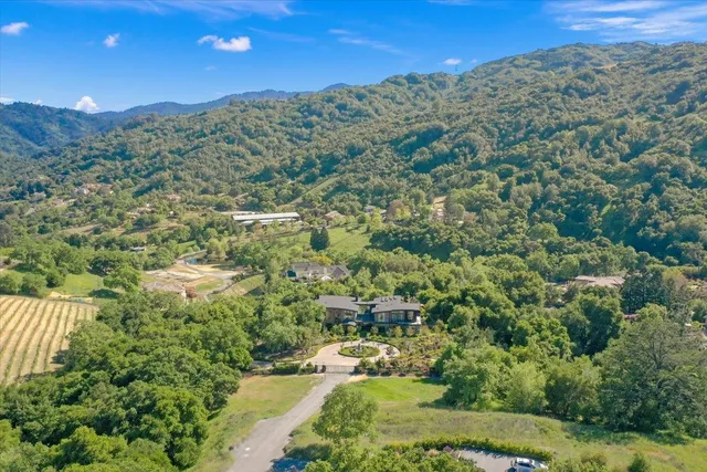 a view of a multi story residential apartment building with a yard