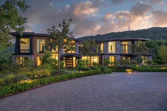 a view of a house with a yard and outdoor seating