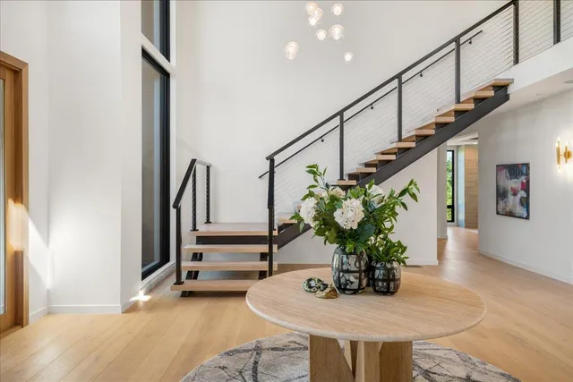 an aerial view of a house with a yard and a large tree