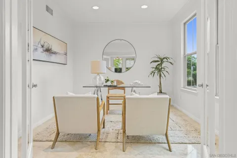 a living room with furniture and a potted plant
