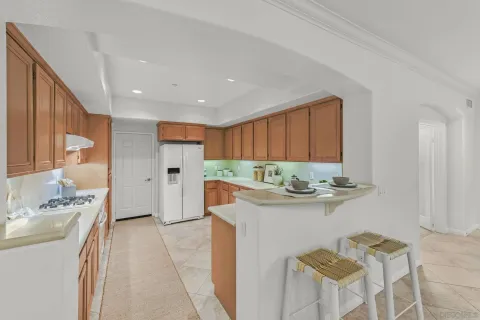a kitchen with stainless steel appliances granite countertop a sink and a refrigerator