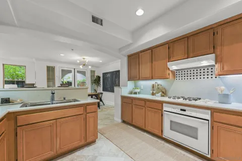 a kitchen with granite countertop a sink and cabinets