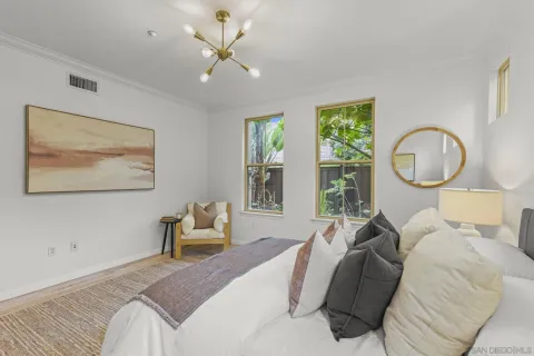 a bedroom with a bed mirror and window