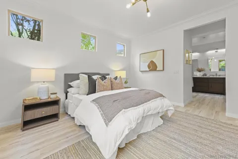 a bedroom with bed and night stand