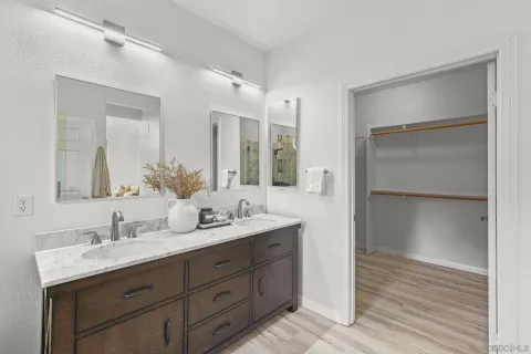 a bathroom with a double vanity sink and mirror