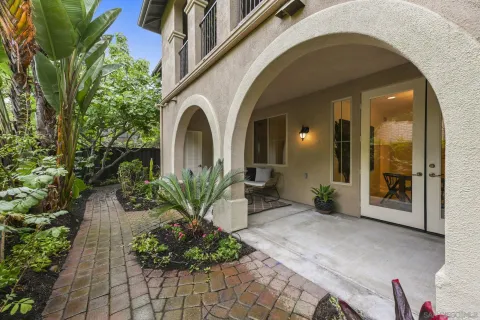 a front view of a house with a garden