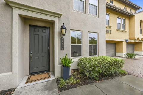 front view of a brick house with a small yard