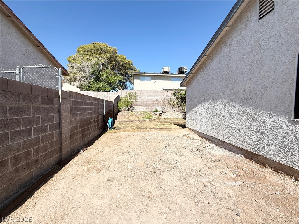 616 Greenway Road Henderson, NV 89002 - Photo 30 of 32 A spacious backyard area awaits your creative vision, ready for personalized landscaping.