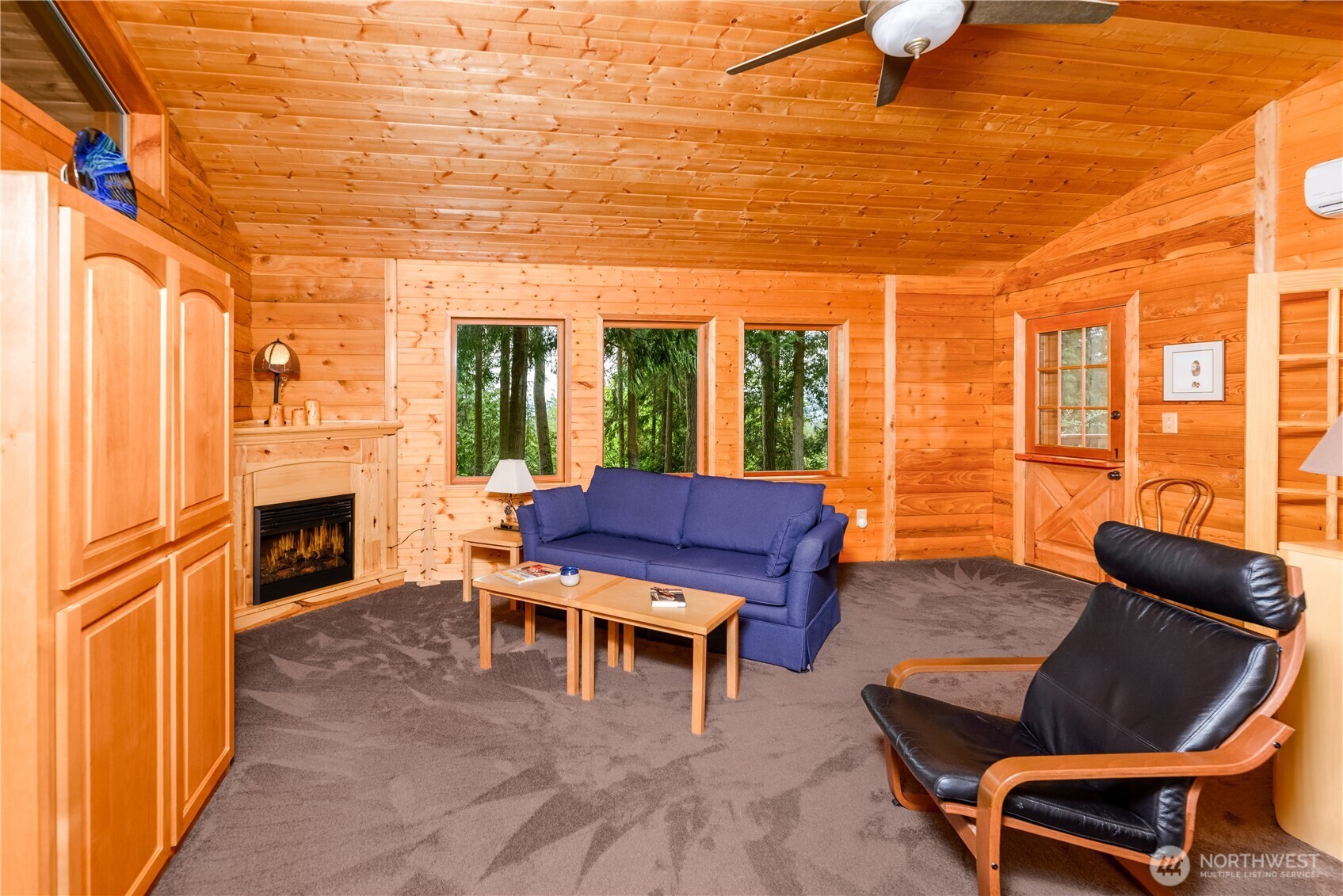 214 Cougar Crest Road Sequim, WA 98382 - Photo 12 of 30 a living room with furniture a fireplace and a flat screen tv