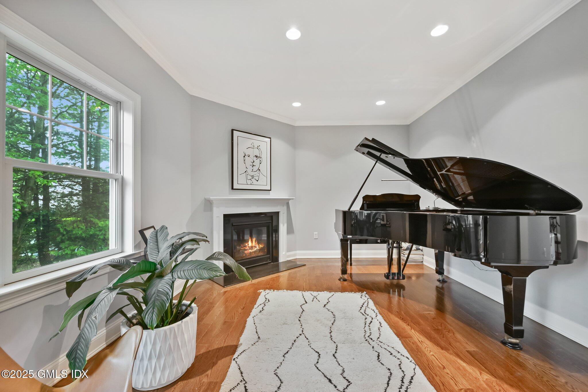8 View Street, Unit 10 Greenwich, CT 06830 - Photo 12 of 26 a living room with furniture a large window and a fireplace