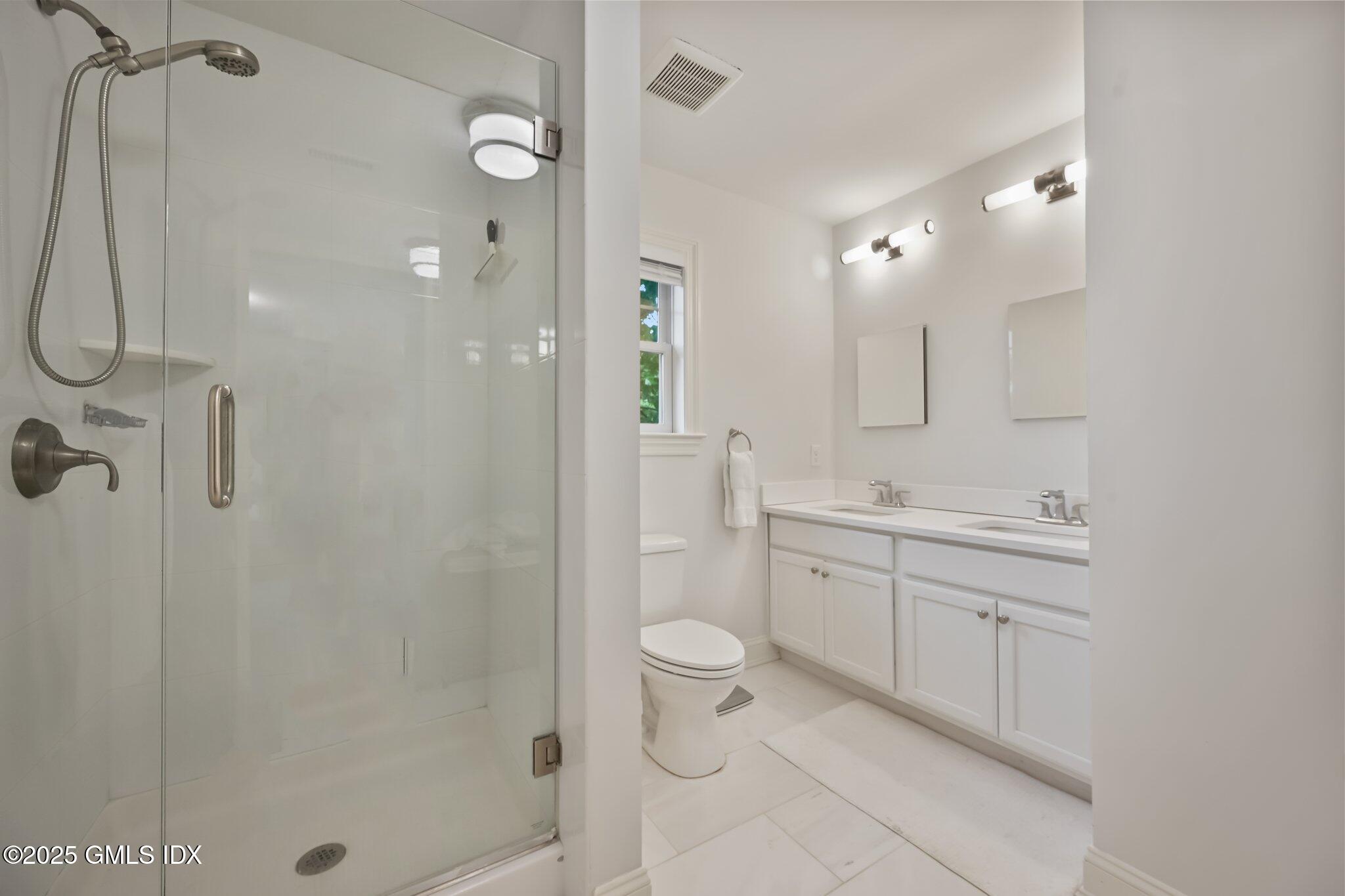 8 View Street, Unit 10 Greenwich, CT 06830 - Photo 15 of 26 a spacious bathroom with a shower sink mirror and toilet