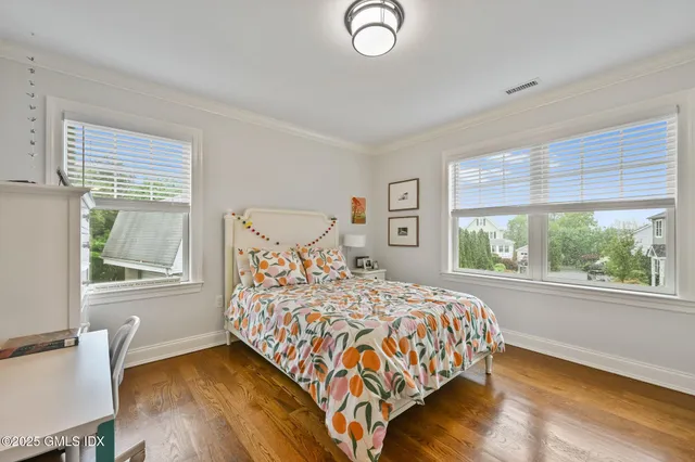 a bedroom with a large bed and a large window