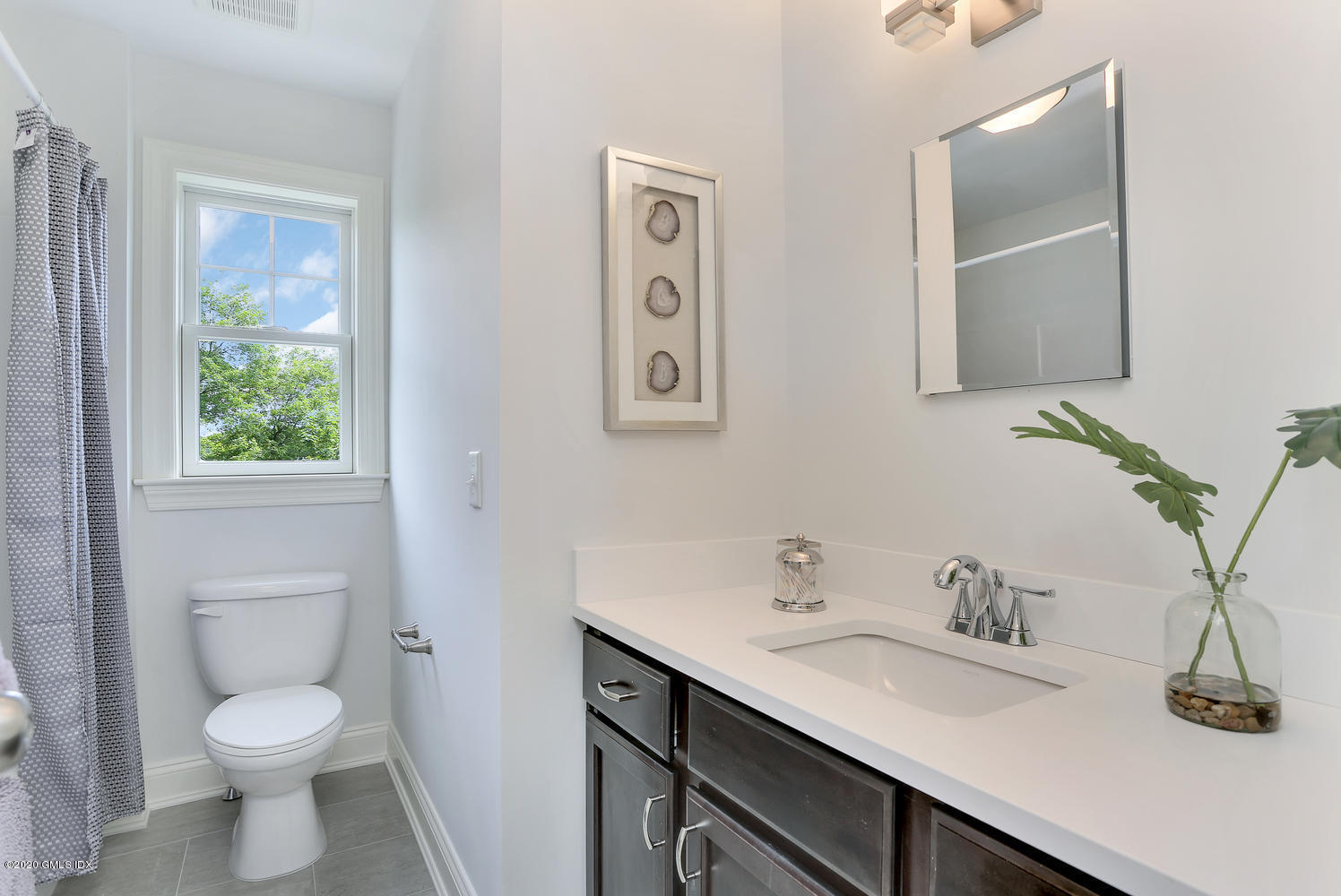 8 View Street, Unit 10 Greenwich, CT 06830 - Photo 18 of 26 a bathroom with a toilet sink and mirror