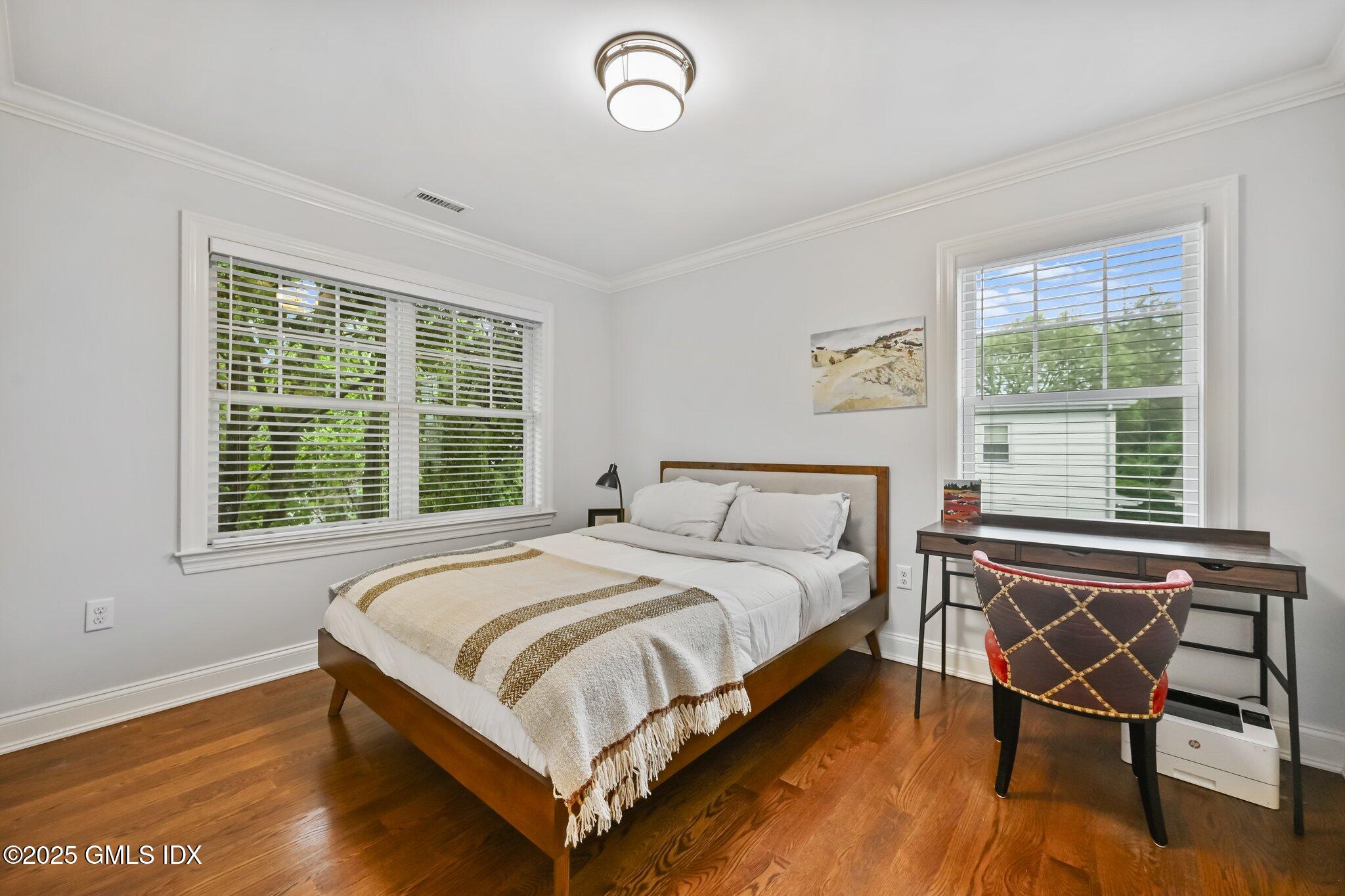 8 View Street, Unit 10 Greenwich, CT 06830 - Photo 19 of 26 a bedroom with a bed chair and a window