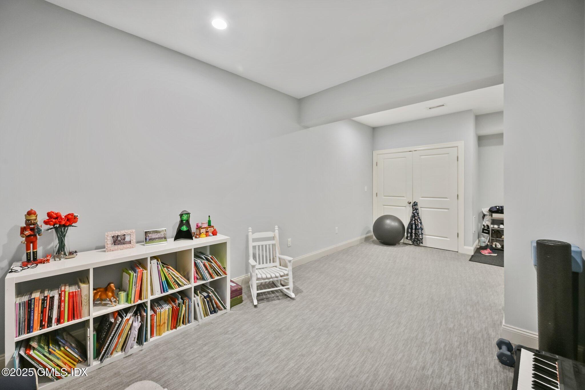 8 View Street, Unit 10 Greenwich, CT 06830 - Photo 20 of 26 a room with furniture and a book shelf