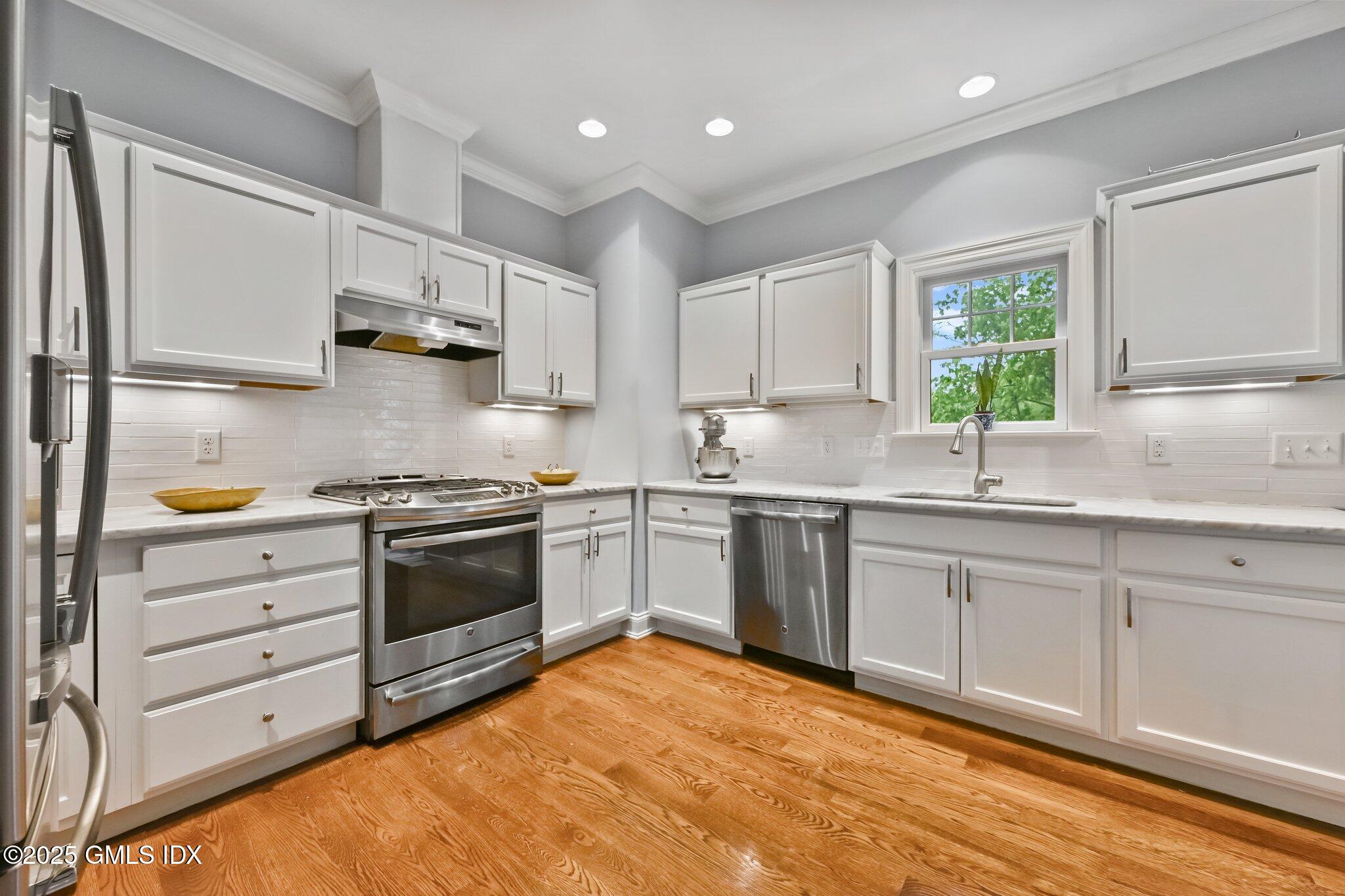 8 View Street, Unit 10 Greenwich, CT 06830 - Photo 9 of 26 a kitchen with granite countertop a sink stainless steel appliances and cabinets