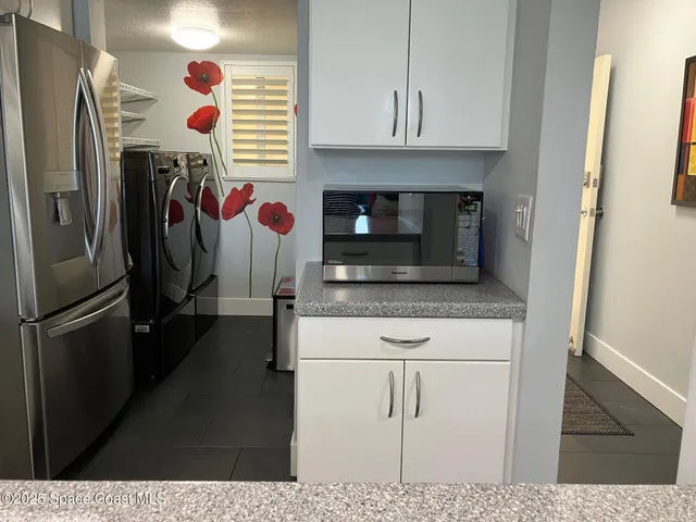 a kitchen with stainless steel appliances granite countertop a refrigerator and a stove