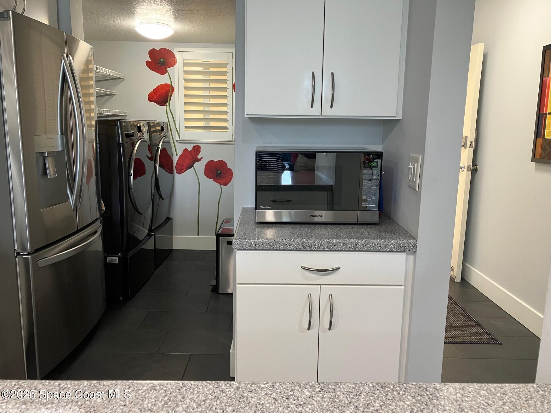 1420 Huntington Lane, Unit 2105 Rockledge, FL 32955 - Photo 15 of 24 a kitchen with stainless steel appliances granite countertop a refrigerator and a stove