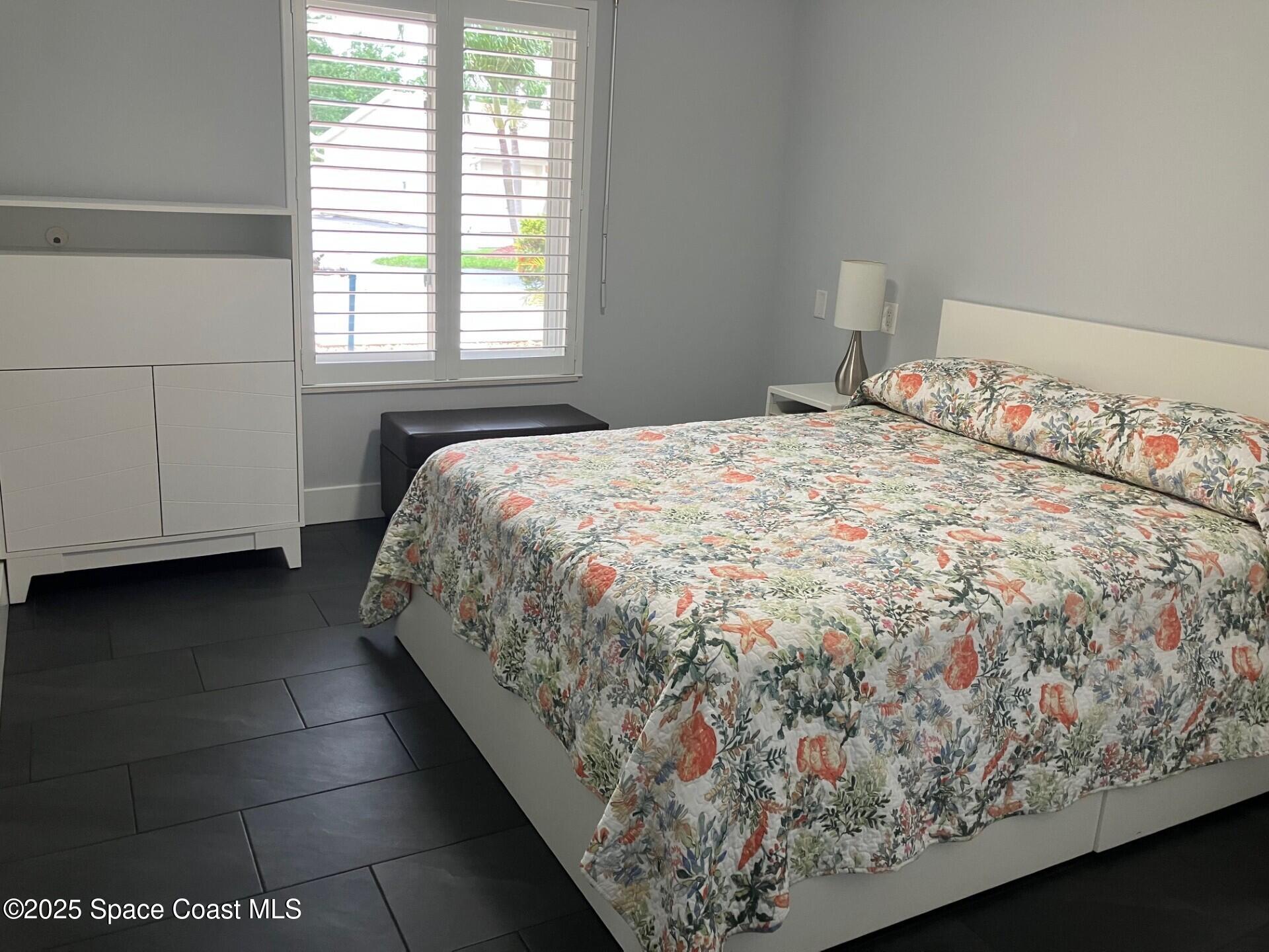 1420 Huntington Lane, Unit 2105 Rockledge, FL 32955 - Photo 18 of 24 a bed sitting in a bedroom next to a window