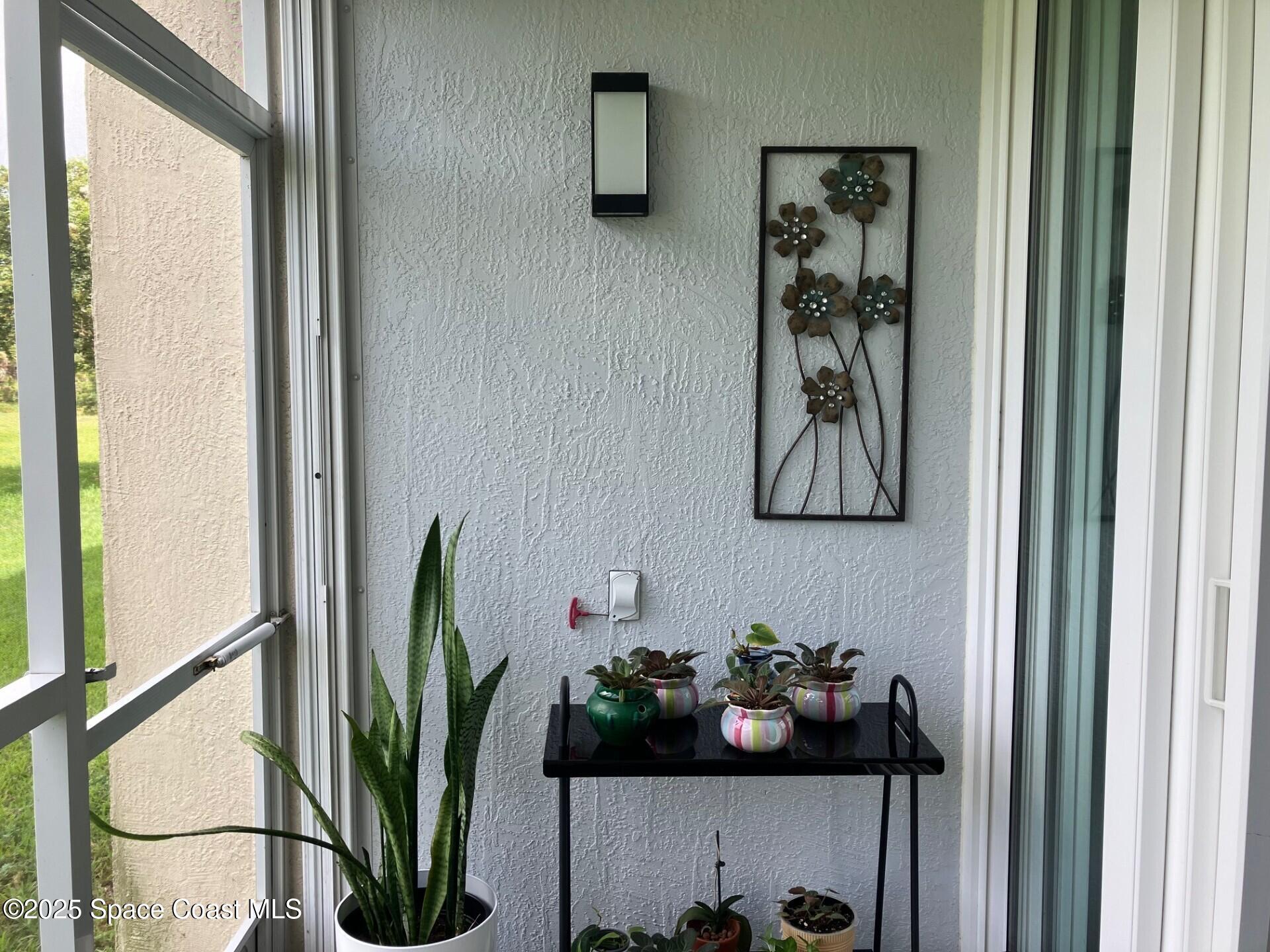 1420 Huntington Lane, Unit 2105 Rockledge, FL 32955 - Photo 3 of 24 a table with a vase of flowers on it