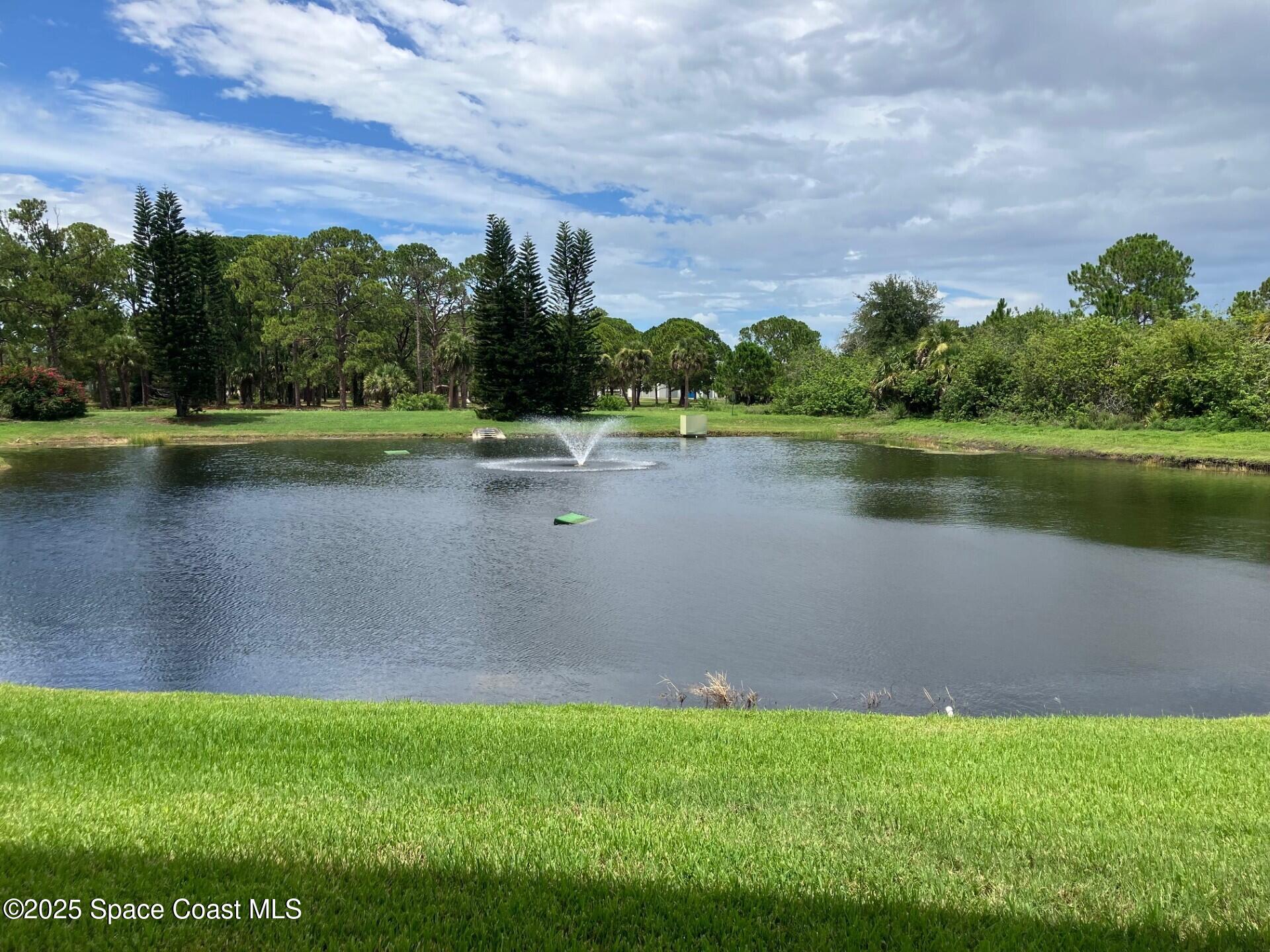 1420 Huntington Lane, Unit 2105 Rockledge, FL 32955 - Photo 4 of 24 a view of a lake with houses in the back