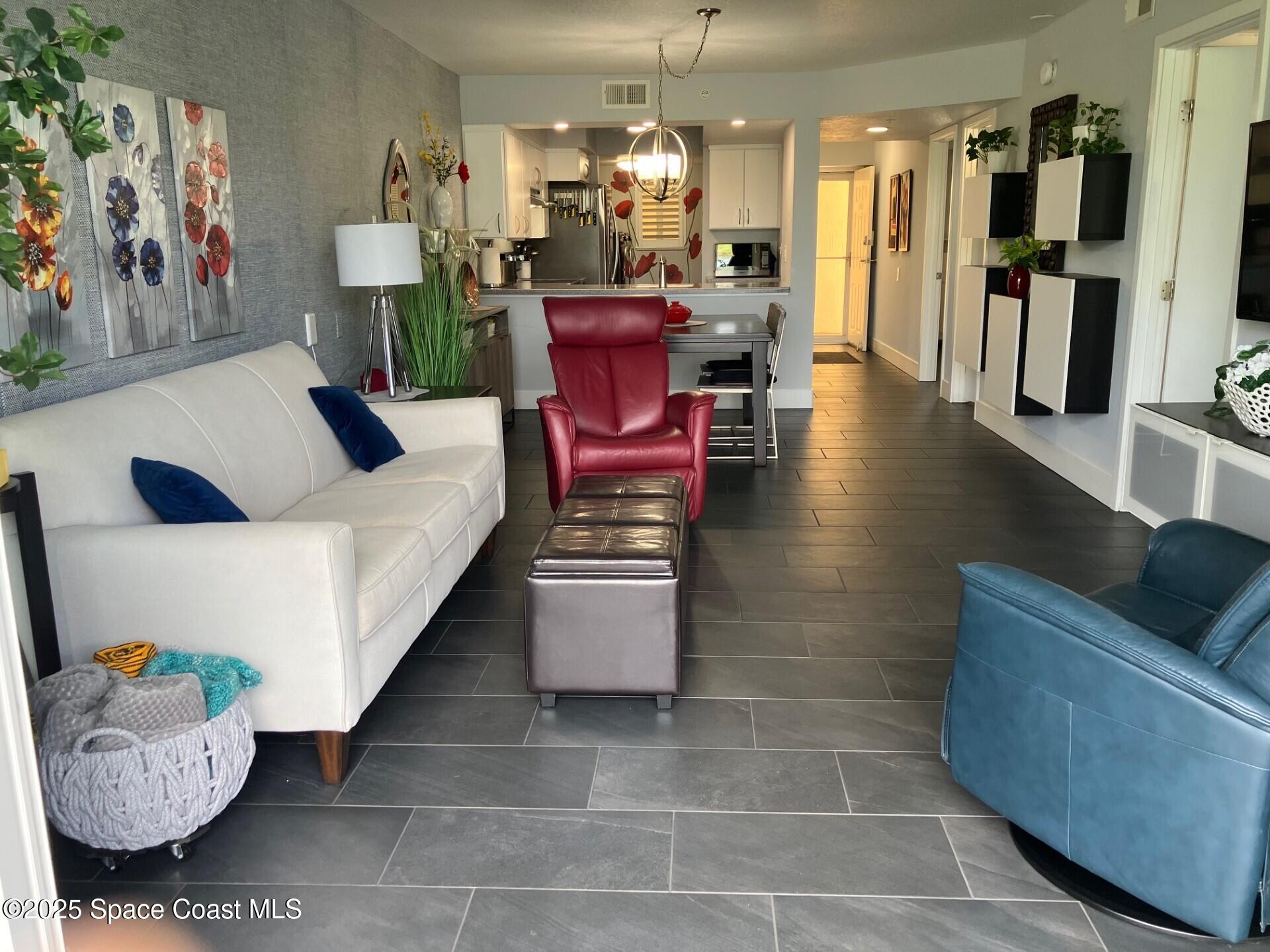 1420 Huntington Lane, Unit 2105 Rockledge, FL 32955 - Photo 5 of 24 a living room with furniture and wooden floor
