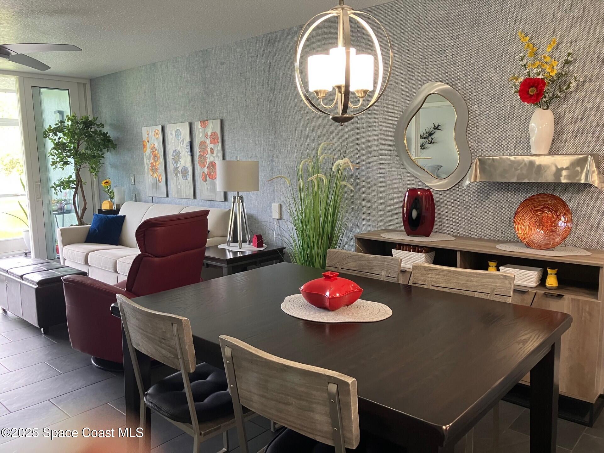 1420 Huntington Lane, Unit 2105 Rockledge, FL 32955 - Photo 6 of 24 a table with dining table and chairs