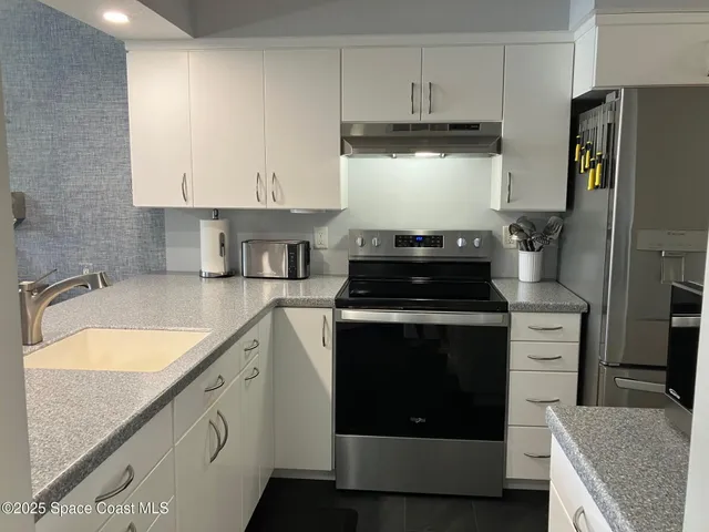 a kitchen with a stove and a refrigerator