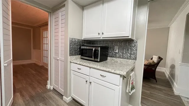 a spacious bathroom with a granite countertop sink and a mirror