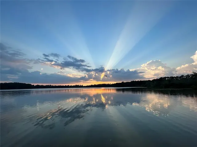 a living room with a dresser and a window
