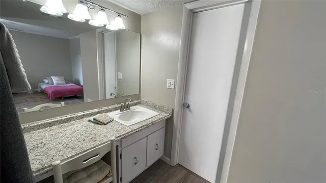 en empty room with wooden floor and furniture