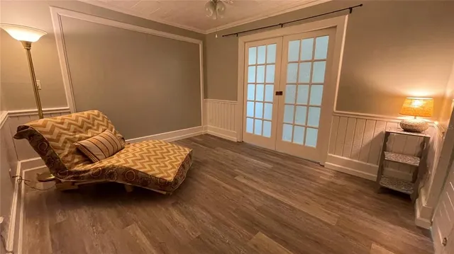 a living room with furniture a flat screen tv and kitchen view
