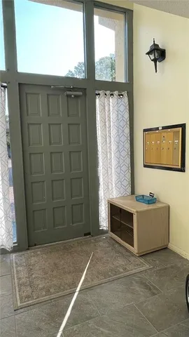 a view of hallway with wooden floor and next to a window