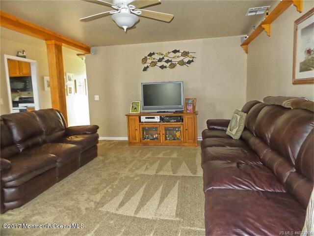 36 Diane Road Manahawkin, NJ 08050 - Photo 9 of 28 a living room with furniture and a flat screen tv