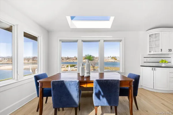 a living room with stainless steel appliances kitchen island granite countertop furniture and a large window