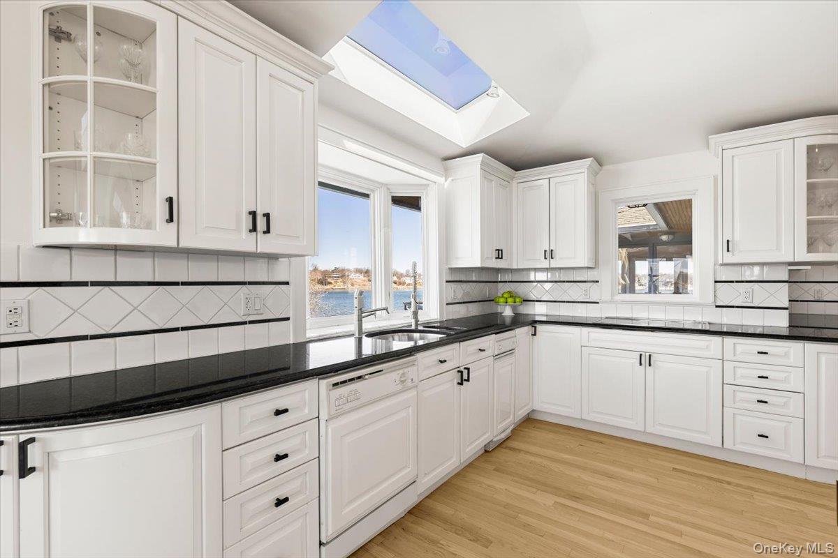 6 North Island Drive Rye, NY 10580 - Photo 20 of 34 a kitchen with granite countertop white cabinets and white appliances