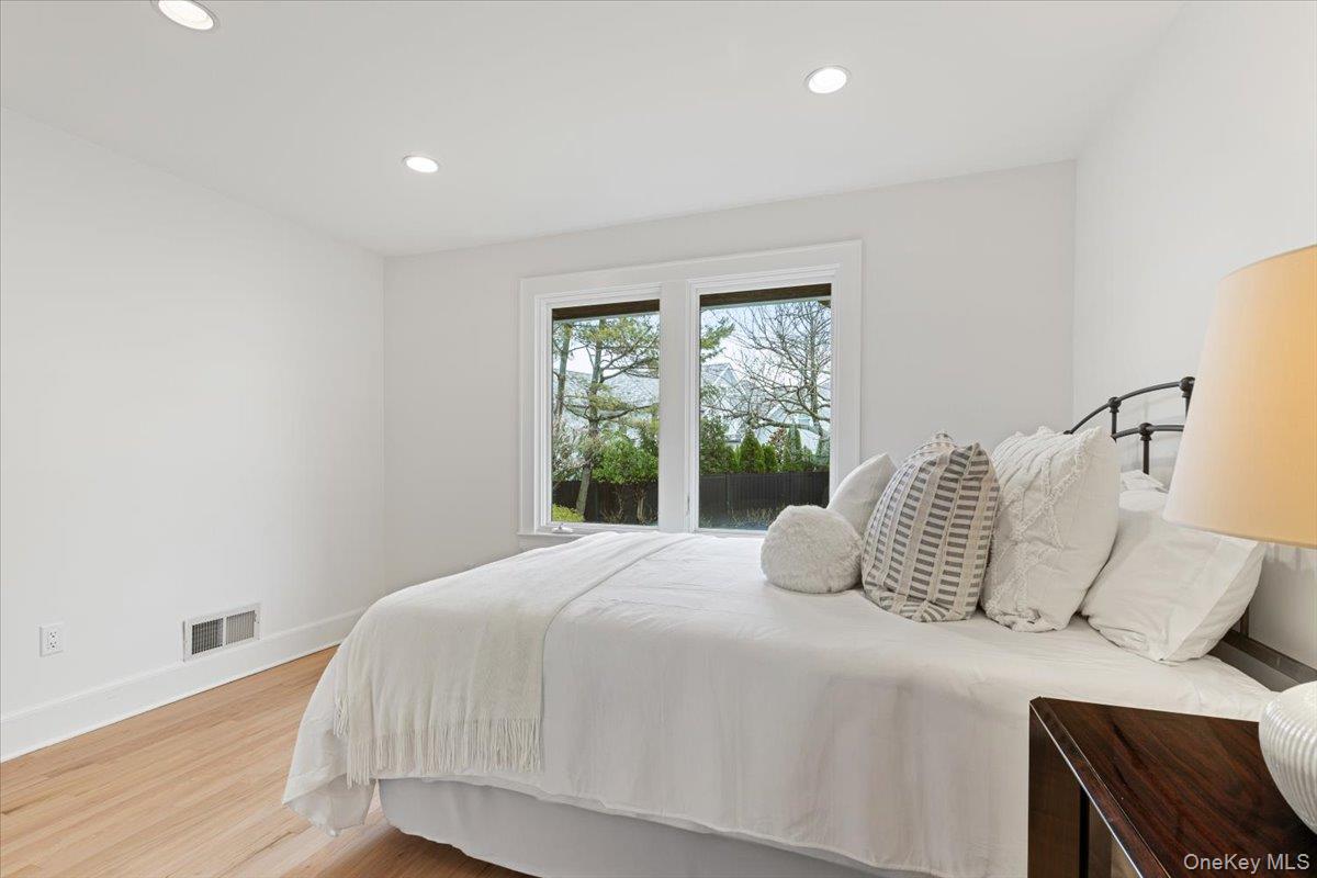 6 North Island Drive Rye, NY 10580 - Photo 21 of 34 a bedroom with a bed and wooden floor