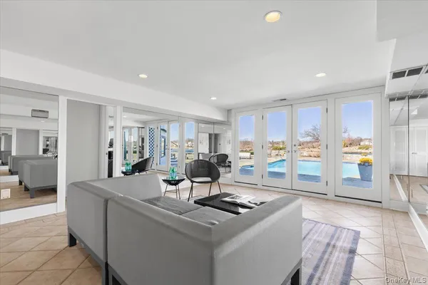 a living room with furniture a flat screen tv and a table