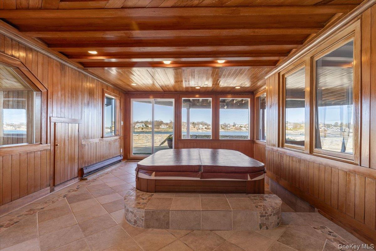 6 North Island Drive Rye, NY 10580 - Photo 29 of 34 a swimming pool with large glass windows and livingroom view