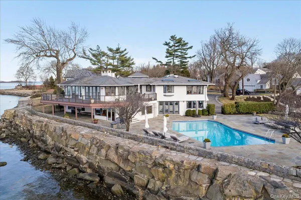 a view of a house with pool and sitting area