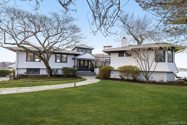 a view of a house with a yard and sitting area